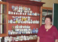 Terry Kurau with her miniature teapot collection